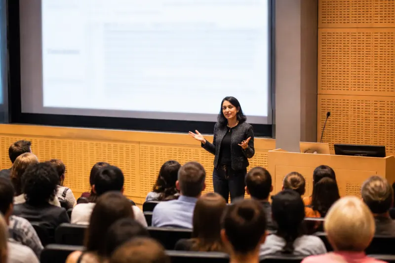 MIT researcher Christian Catalini speaking at a university event regarding AI responsibilities.