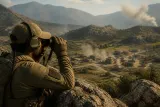 A player in Wardogs using binoculars to spot enemies from a hilltop.