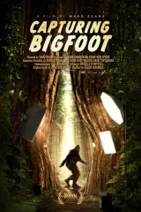Poster for Capturing Bigfoot (2026) showing a grainy forest silhouette with film reel motif