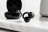 A close-up of the Sony LinkBuds Clip in black, showcased with their unique clip-style design.