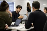 A group of AI researchers in a discussion about safety measures in artificial intelligence.