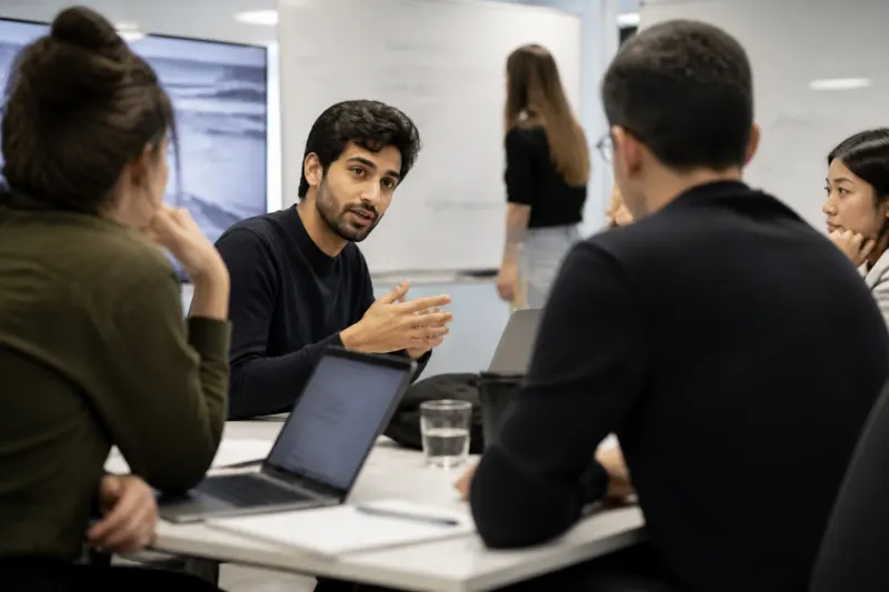 A group of AI researchers in a discussion about safety measures in artificial intelligence.