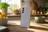 A Samsung Galaxy S24 smartphone displayed prominently on a wooden table.