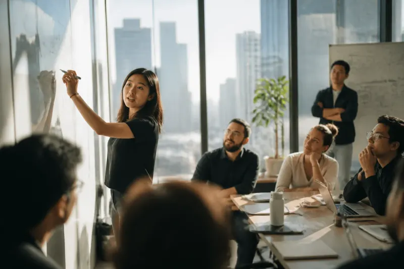 A gathering of AI safety researchers discussing AI safety measures in a meeting room with diverse participants.