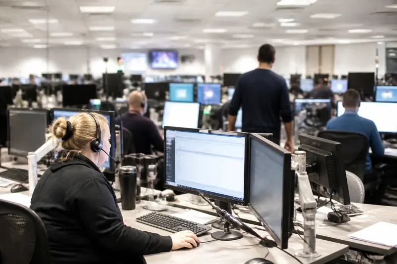 A busy dispatch area with workers handling requests affected by server routing issues.
