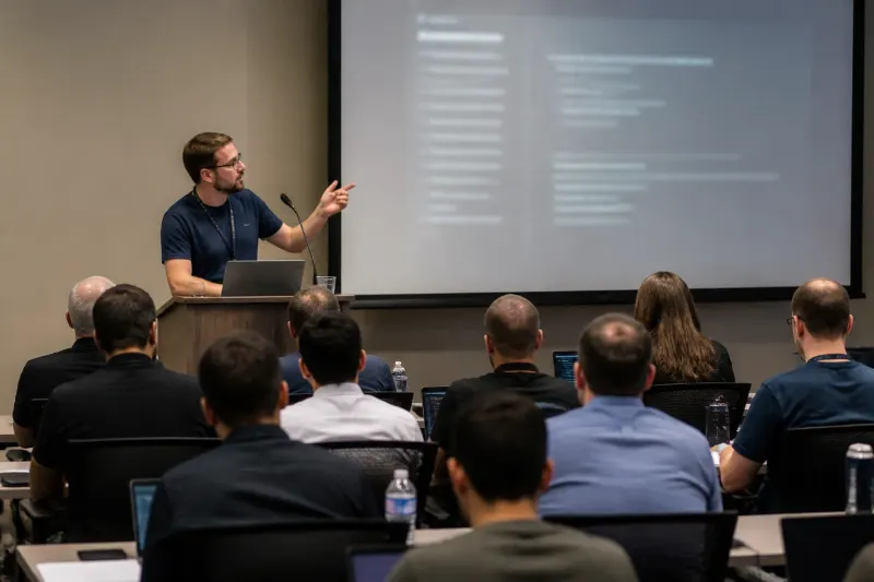 A researcher demonstrating the BragJack attack on a browser at a cybersecurity conference.