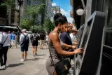 A street view of cryptocurrency kiosks with diverse passersby.