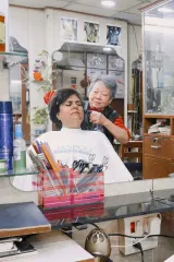 Poster for A Sunflower in Delhi (2026) showing a beauty parlour interior with women of different ages, natural grey hair visible, warm fluorescent lighting