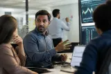 A financial analyst discussing cryptocurrency trends in a lively office environment.