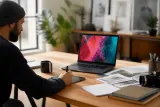 An Nvidia RTX Spark laptop setup in a creative workspace with vibrant display.