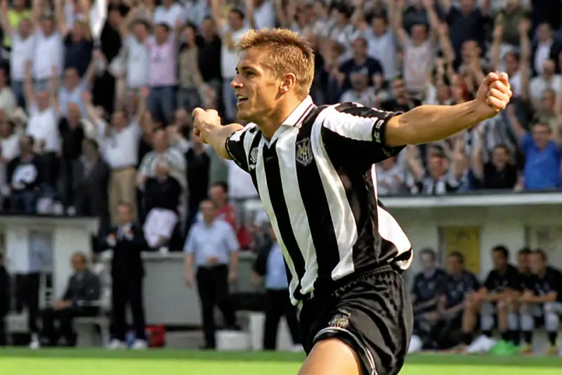 A Premier League footballer celebrating after scoring a goal.