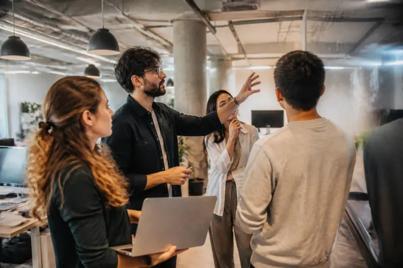 A meeting with developers discussing strategies to improve AI functionalities.
