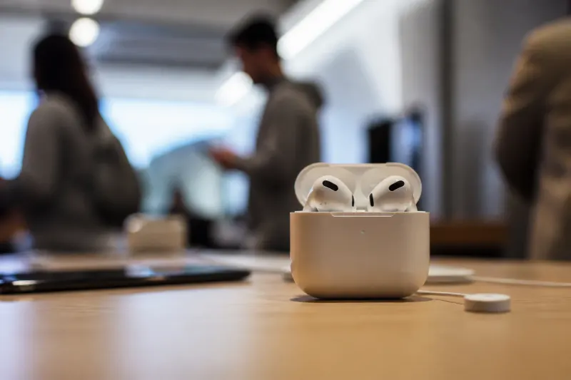 Apple AirPods 5 displayed on a vibrant background