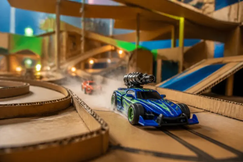 A colorful screenshot from Stuntboost showing a high-speed racing scene in a creative environment.