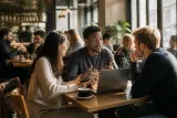 A group of investors discussing staking options at a busy café.