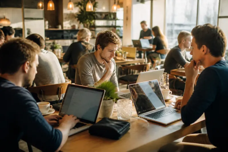 A busy café with chairs and coffee cups, while investors wait for staking rewards.