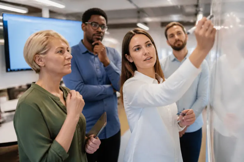 Group of cybersecurity experts examining AI risks in a meeting