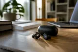 Sennheiser Accentum Clip earbuds displayed with their charging case